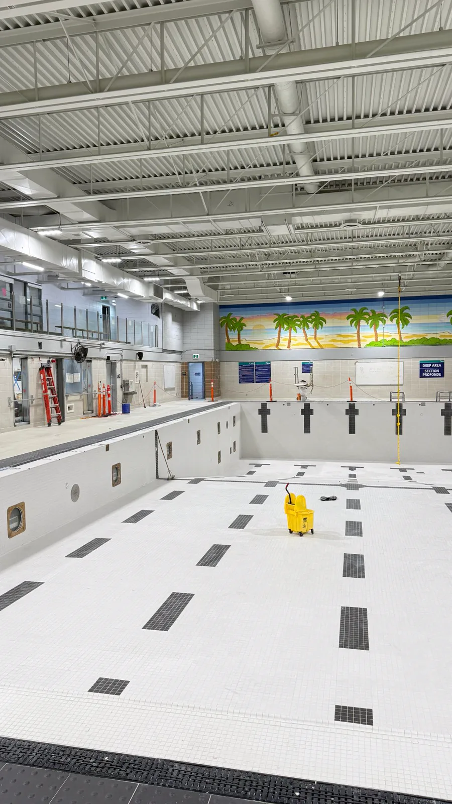 Tiled pool walls with black target crosses on the end wall