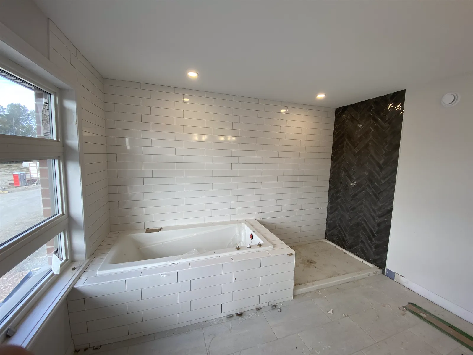 Soaker tub with a herringbone tile accent