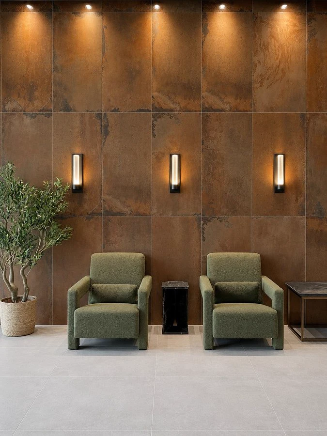 Lobby lounge seating against the copper-finish wall